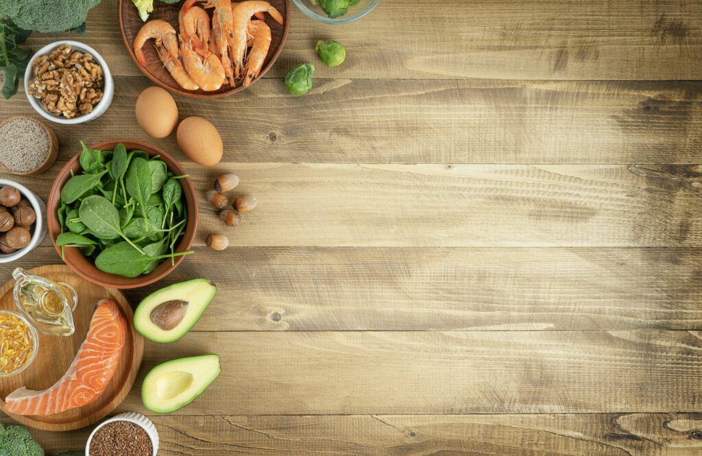 Selection of keto diet food sources on wooden background. Top view, copy space.