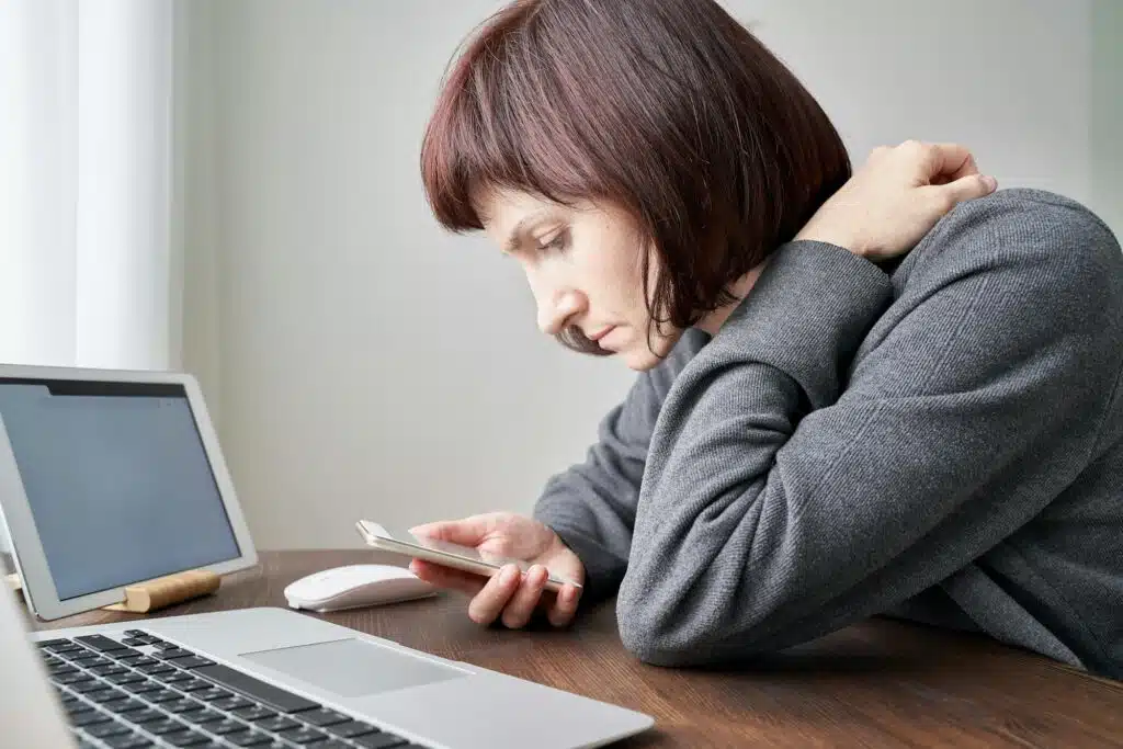 Woman with digital addiction using mobile phone, laptop and tablet
