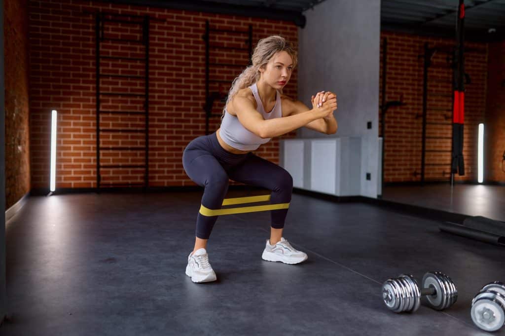 Woman training with fitness rubber band